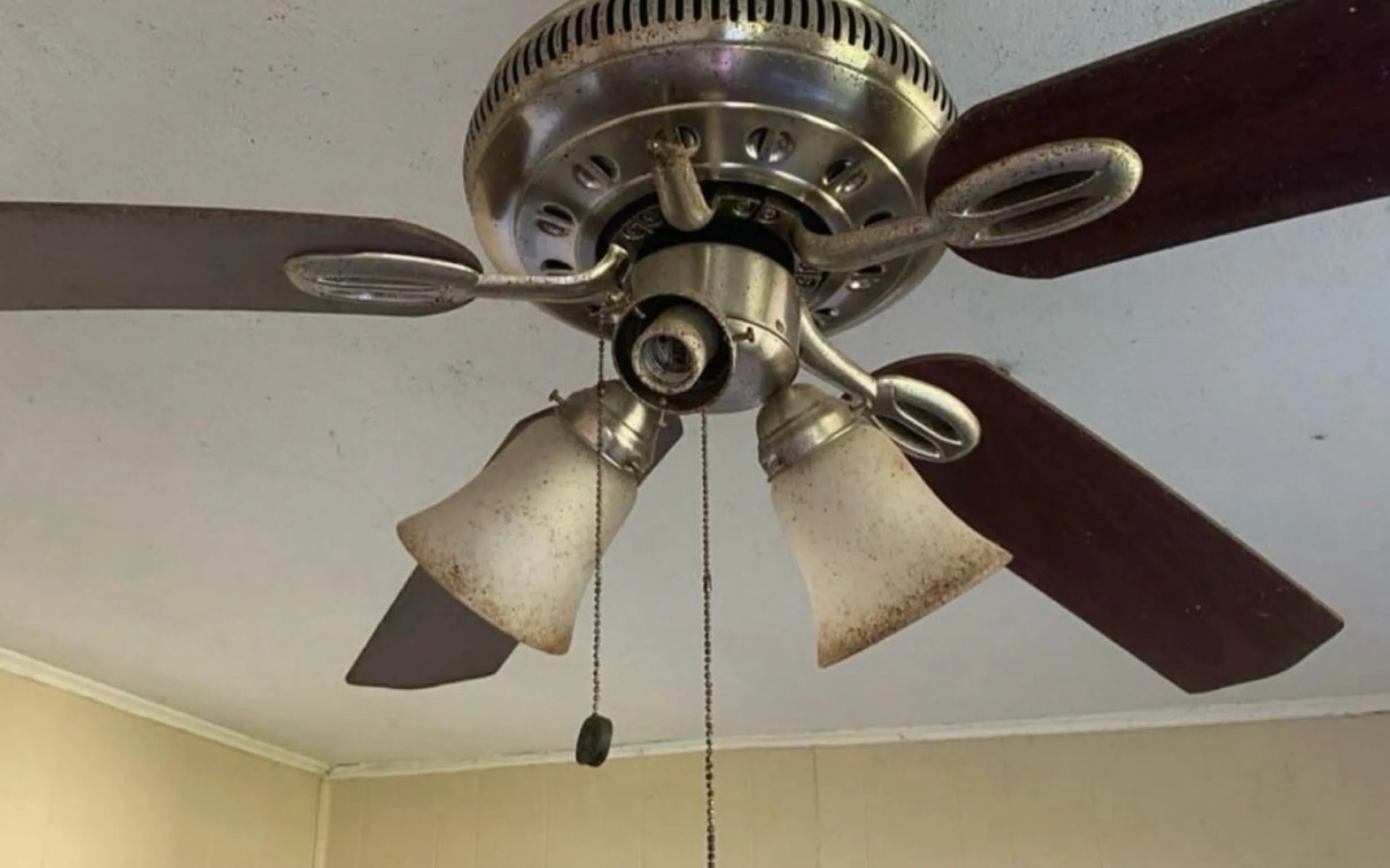 Dusty ceiling fan blades before cleaning